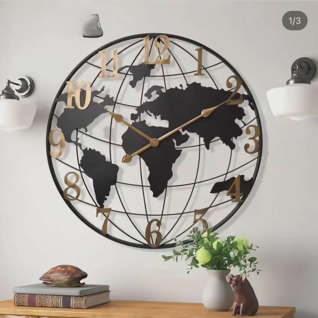 60cm black and gold world map wall clock with silent movement, mounted on a living room wall with modern decor.