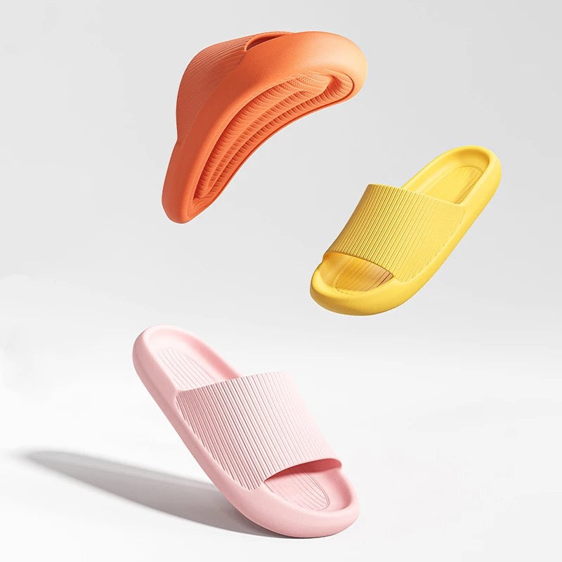 Fitlybuy Cloud Slides with ComfortFoam in orange, yellow, and pink, floating against a clean white studio background.