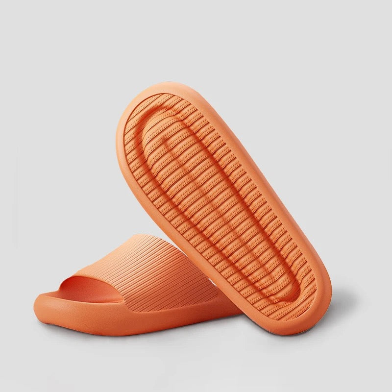 Fitlybuy orange Cloud Slides featuring ComfortFoam cushioning with a textured, slip-resistant sole on a gray background.