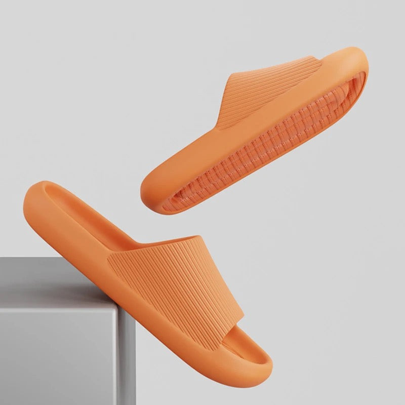 Orange Fitlybuy Cloud Slides featuring a textured strap and ComfortFoam cushioning, displayed in a levitating pose.