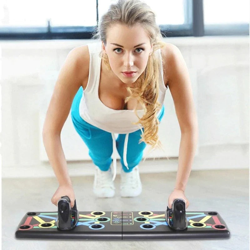 Woman performing push-ups on a Fitlybuy black multi-functional folding board with color-coded ergonomic grip slots.