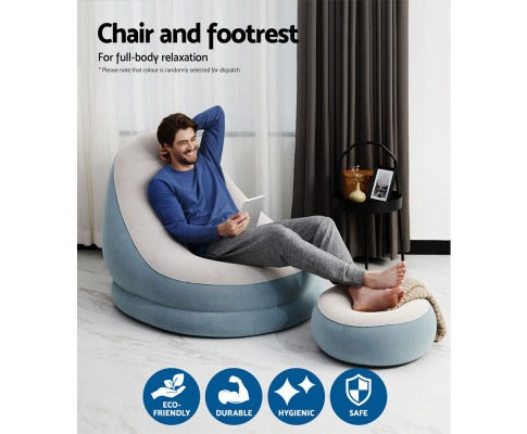 Man relaxing on a blue and beige Fitlybuy inflatable air chair and footrest set in a modern living room.