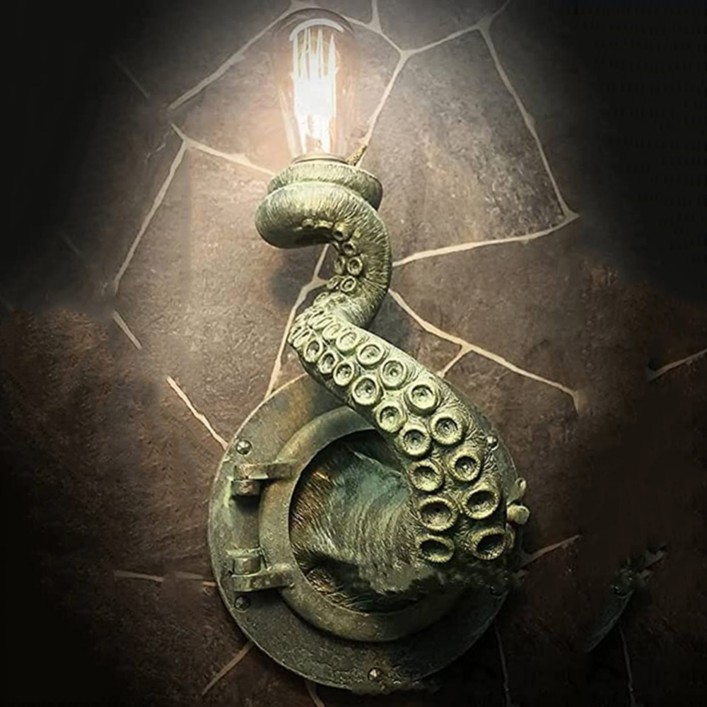 Bronze-colored octopus tentacle wall light with Edison bulb, emerging from a nautical porthole mount on a stone wall.