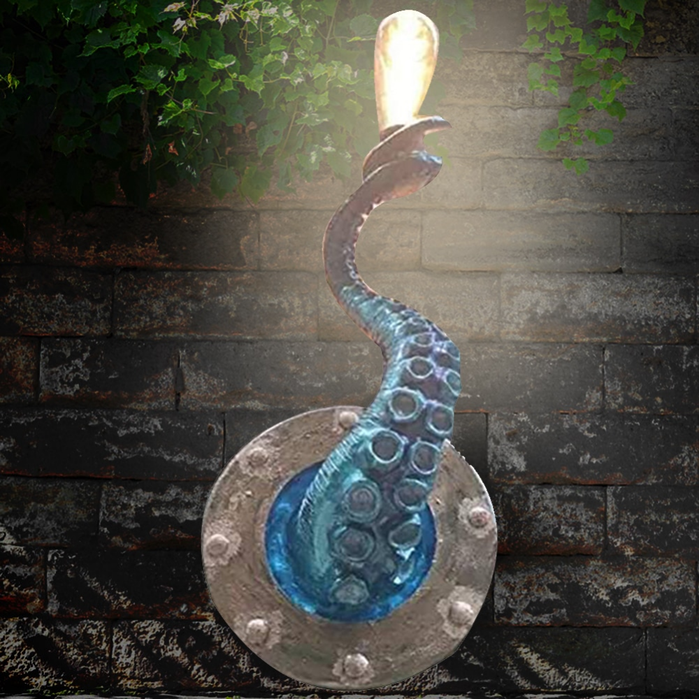 Fitlybuy Krakenna teal octopus tentacle wall light with a glowing bulb, mounted on a brick wall with ivy.
