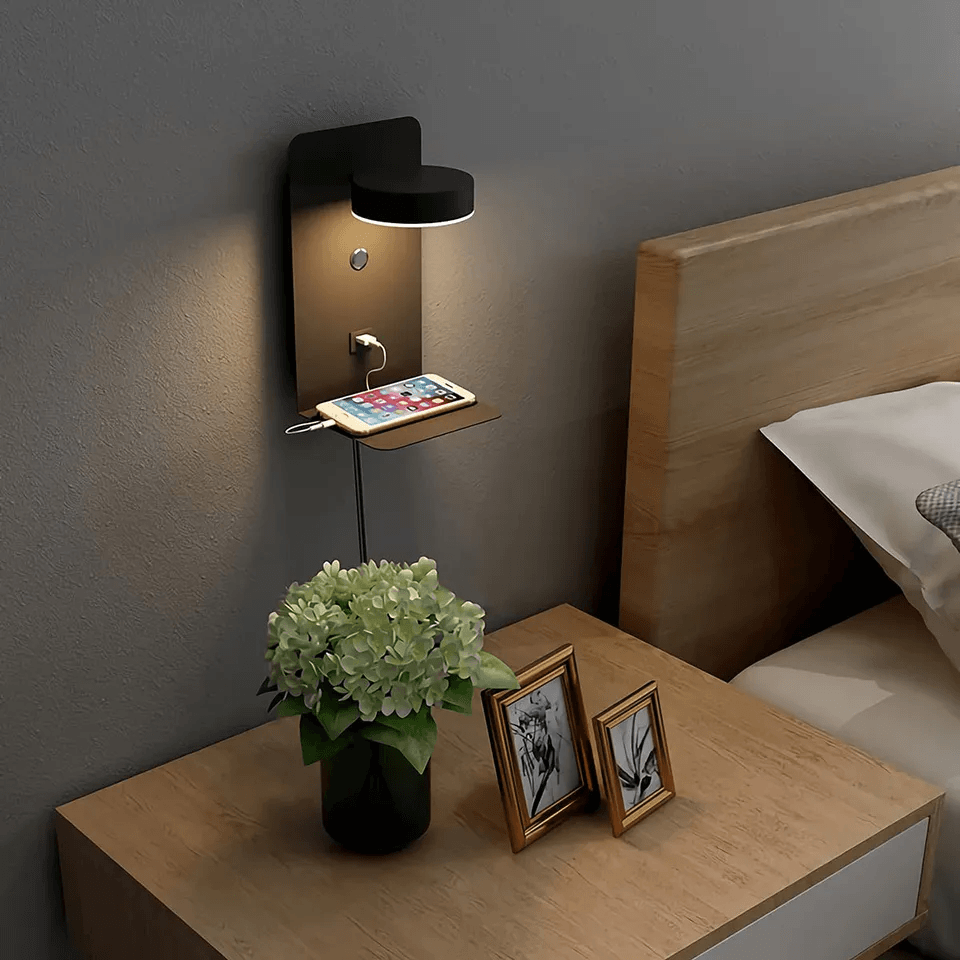 Black Fitlybuy BrightSpot night lamp mounted on a wall with rotating LED, USB-C charging dock, and phone shelf.