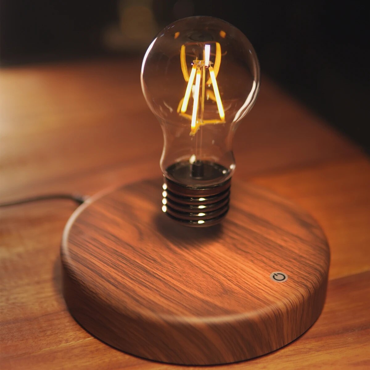 Fitlybuy Levion levitating Tesla lamp with a glowing LED bulb floating above a round, dark wood base.