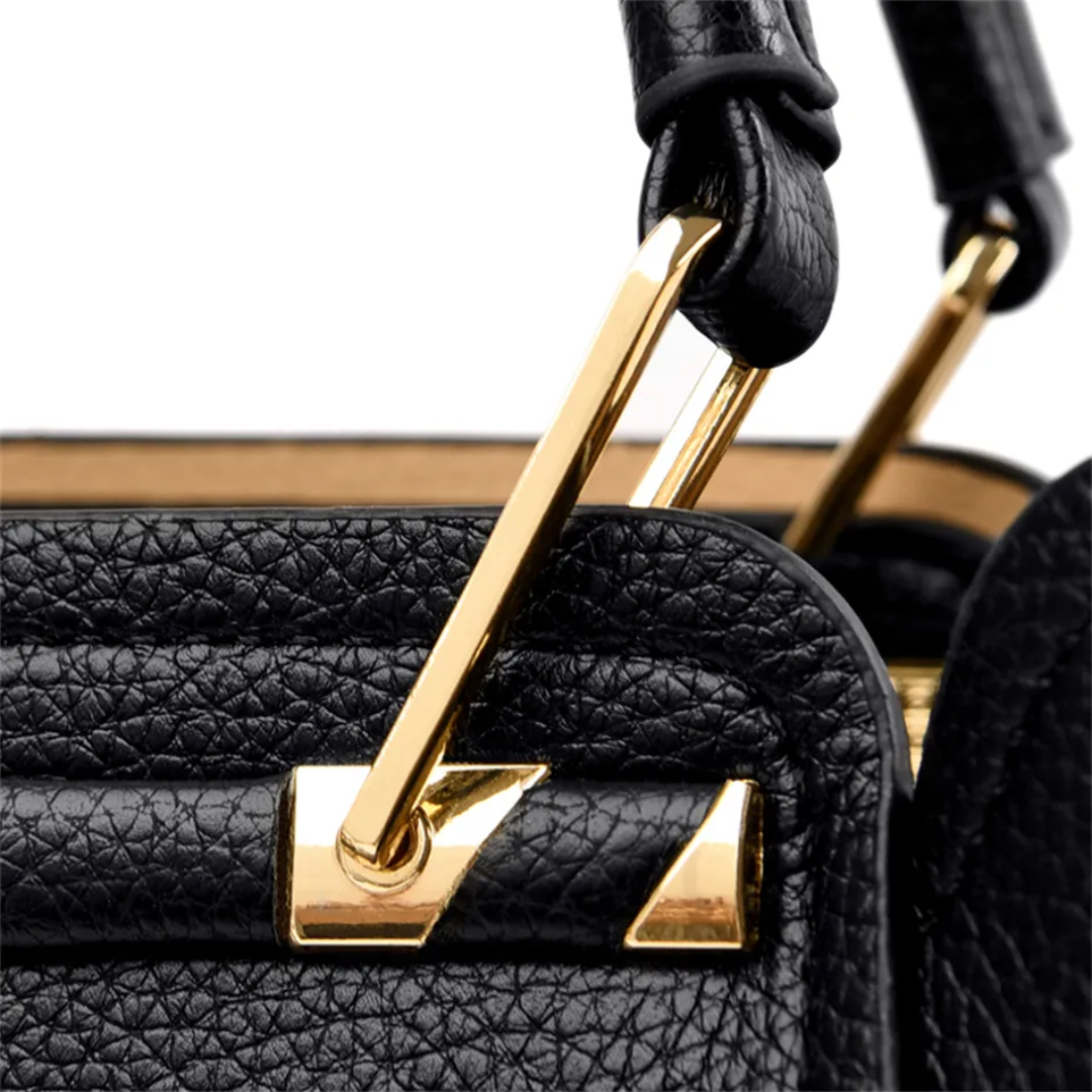 Close-up of black pebble-grain PU leather Fitlybuy Vivian shoulder bag with elegant gold-tone metal hardware clips.