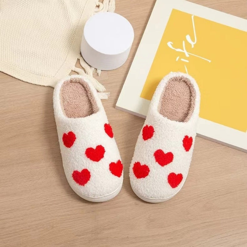 Fitlybuy white memory foam slippers with red heart patterns, soft plush lining, displayed on a wooden surface.