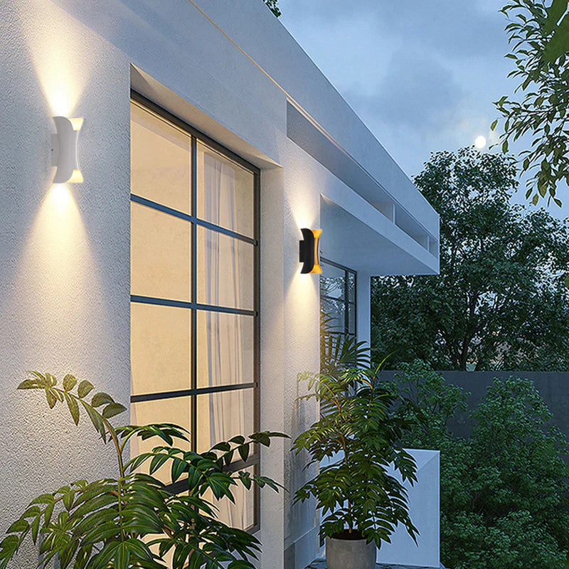 Fitlybuy Lumio waterproof LED wall lights in black and white mounted on a modern house exterior at dusk.