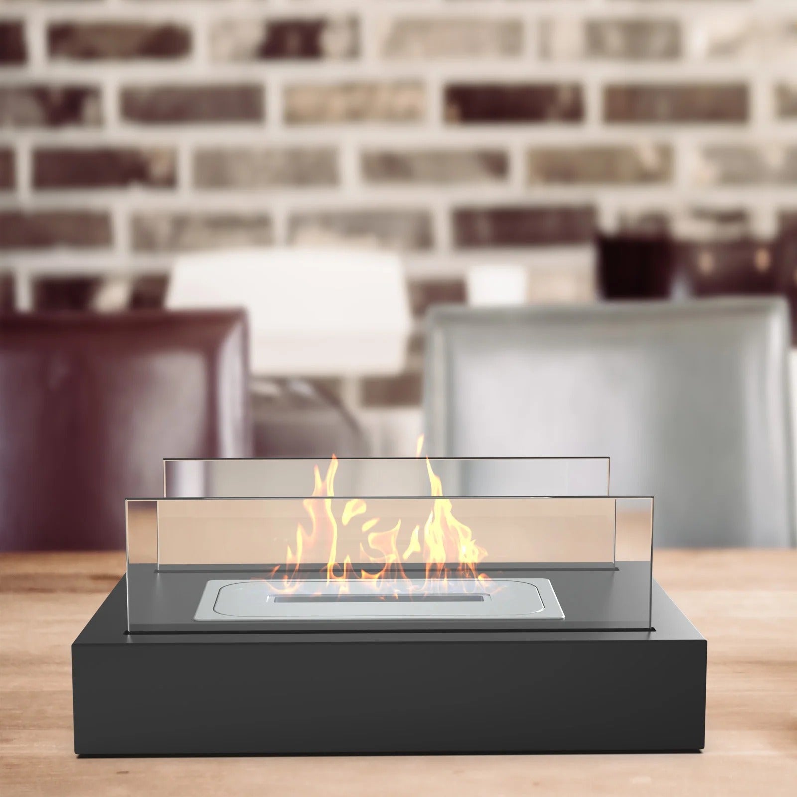 Black Fitlybuy tabletop bio-ethanol fireplace with glass guards and a smokeless flame on a wooden dining table.