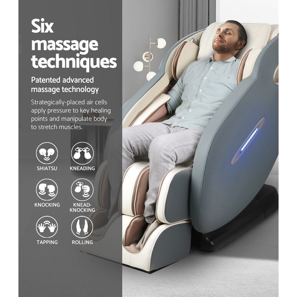 Man in a grey and white Fitlybuy Deluxe Massage Chair featuring ComfortWave tech and six massage modes.