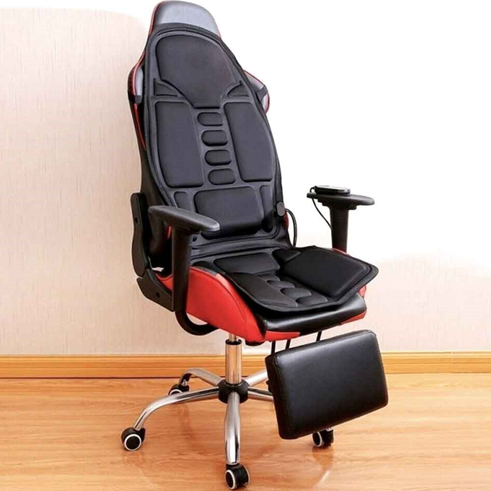 Fitlybuy black 8-mode heated massage chair pad on a red and black gaming chair with footrest in a room.