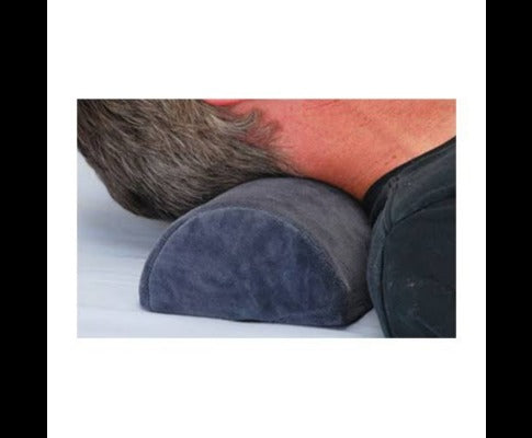 Grey semi-cylindrical memory foam support pillow being used under a person's neck for ergonomic comfort.