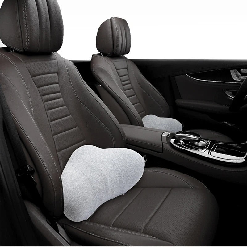 Fitlybuy grey memory foam lumbar pillow with ergonomic design placed on dark leather car seats.