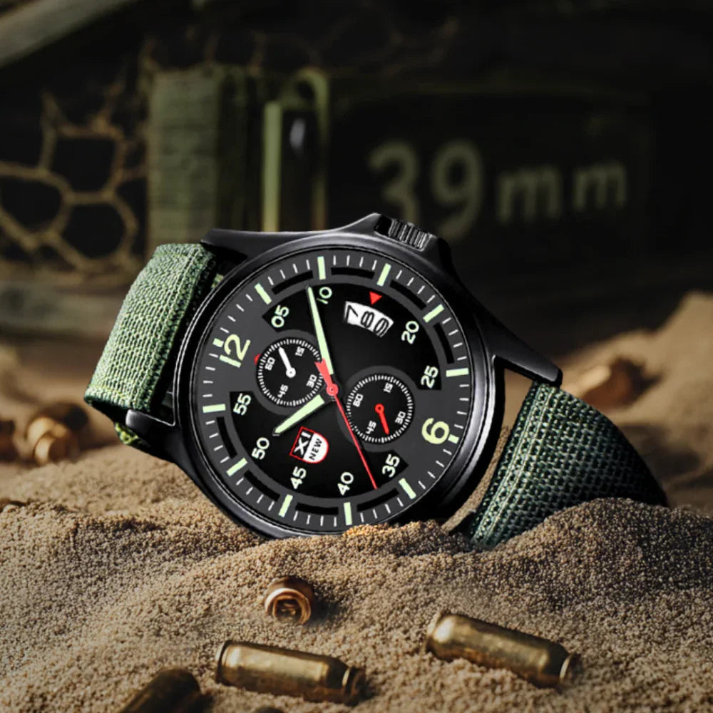 Fitlybuy military quartz watch with black dial, luminous hands, and olive green tactical nylon strap in a sandy setting.