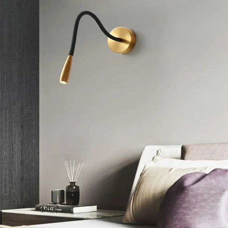 Fitlybuy TrendyShine adjustable black-and-gold wall lamp with LED light mounted above a bedroom nightstand.
