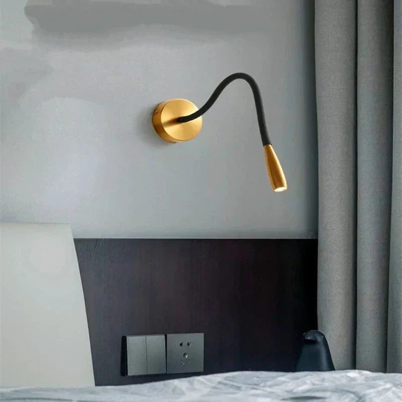Fitlybuy TrendyShine adjustable gold and black LED wall lamp mounted above a modern bedroom headboard.