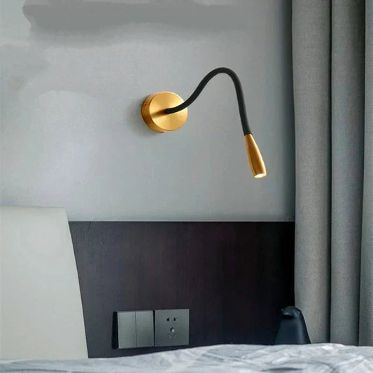 Fitlybuy TrendyShine adjustable gold and black LED wall lamp mounted above a modern bedroom headboard.