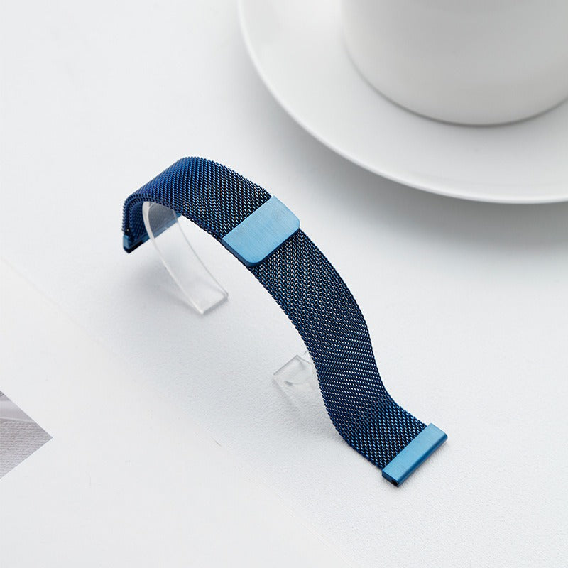 Blue Fitlybuy Milanese stainless steel mesh watch strap with adjustable magnetic clasp on a white display stand.