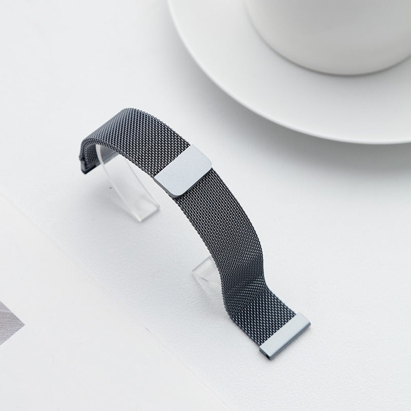 Grey Fitlybuy Milanese stainless steel mesh watch strap with adjustable quick-release design on a white surface.