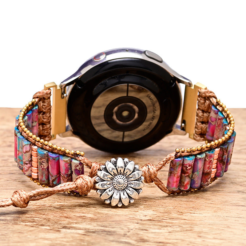Fitlybuy purple floral stone bracelet watch band with woven cord and silver flower clasp on a wooden surface.