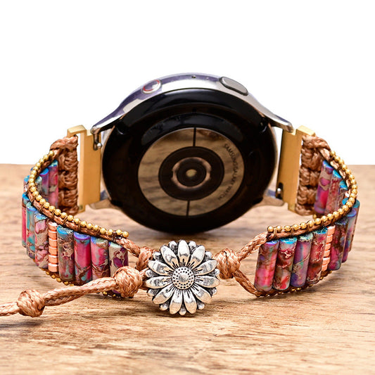 Fitlybuy purple floral stone bracelet watch band with woven cord and silver flower clasp on a wooden surface.