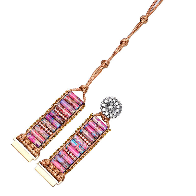 Boho watch band featuring purple and pink cylindrical natural stones woven with brown cord and a silver flower charm.