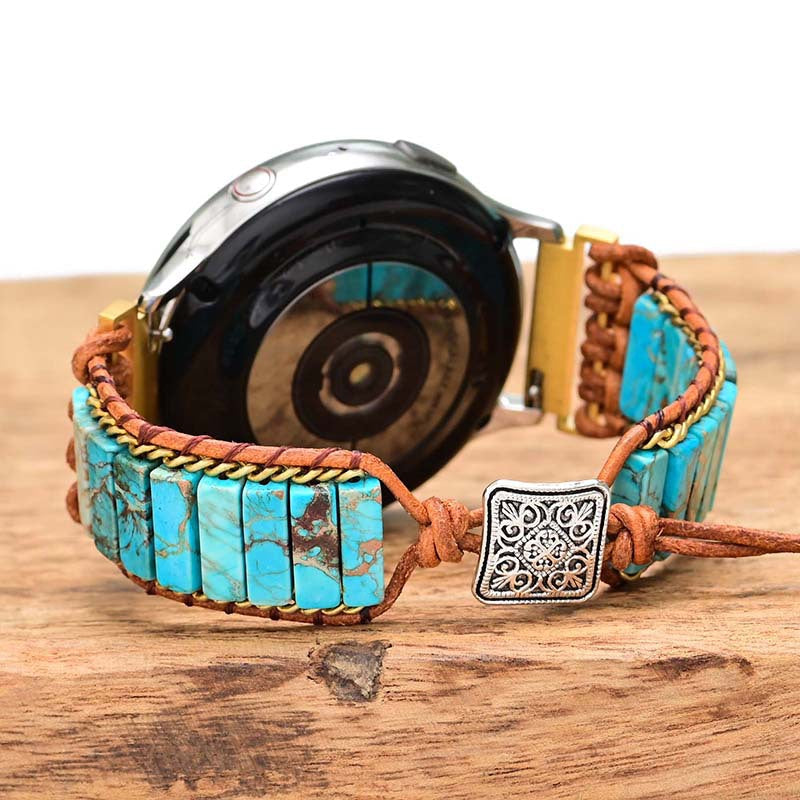 Fitlybuy watch with turquoise stone cylindrical beads, woven leather band, and silver clasp on a wooden surface.