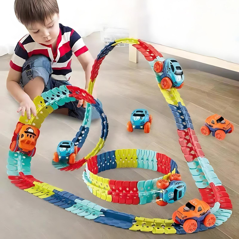 Child playing with Fitlybuy MagniTrack: colorful, flexible magnetic car track set with small blue and orange toy cars.