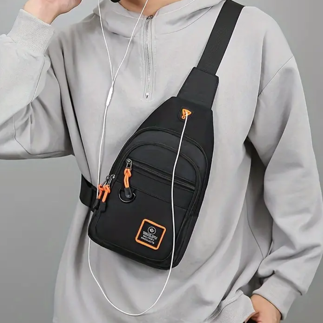 Fitlybuy UrbanTrail black waterproof crossbody chest bag with orange accents, worn by a man in a gray hoodie.