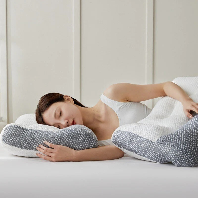 Woman sleeping on a white and grey Fitlybuy ergonomic pain relief pillow with adaptive foam contour design.