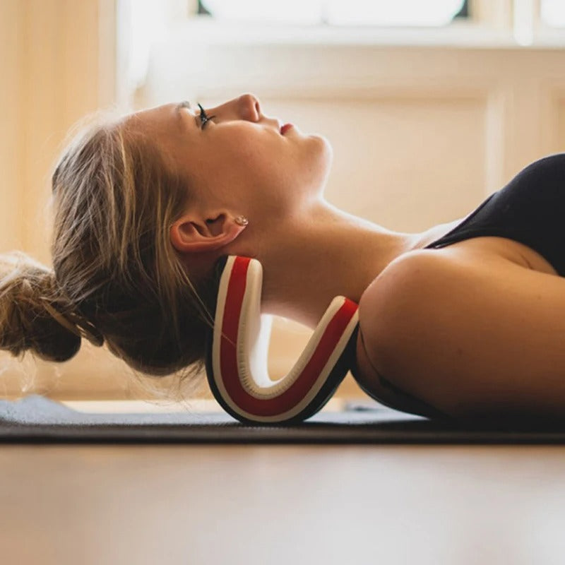 Woman lying on a mat using a white and red Fitlybuy orthopedic neck stretcher for ergonomic cervical support.