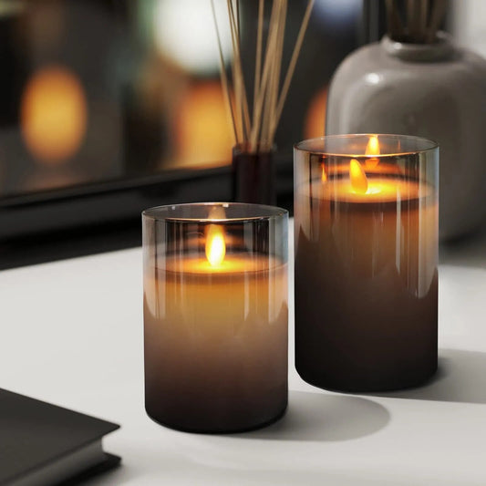 Fitlybuy AuraFlame LED flameless candles in gradient grey glass cylinders glowing with realistic warm flickering flames.