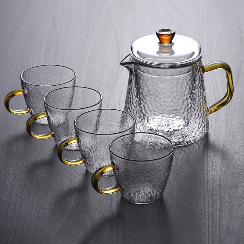 Fitlybuy Pindefang glass teapot and four cups set with textured clear glass and elegant golden handles on dark wood.