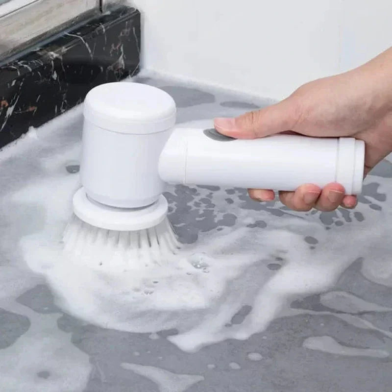 White Fitlybuy cordless electric scrubber cleaning a soapy surface with a round brush attachment.
