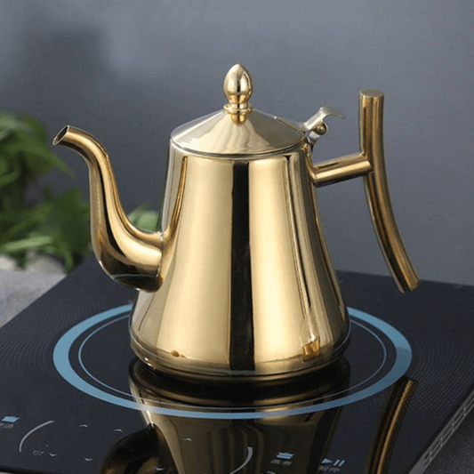 Gold Fitlybuy PureBoil stainless steel induction kettle with a spout and lid on a black stovetop.