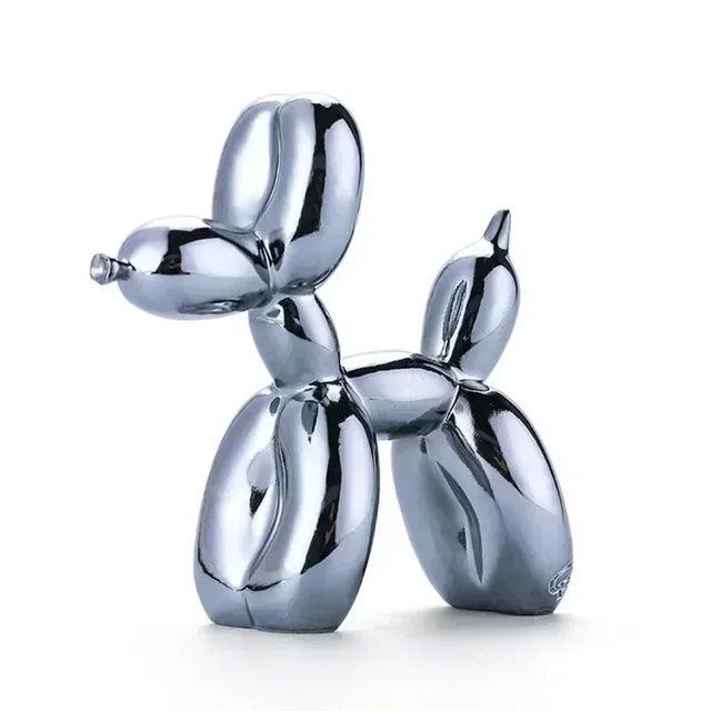 Shiny silver chrome balloon dog sculpture with a smooth, reflective finish, isolated on a white background.
