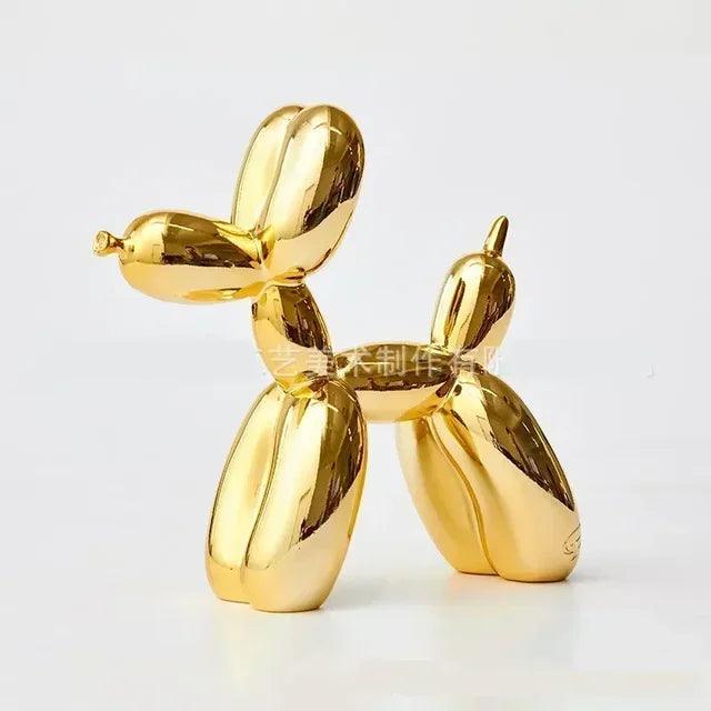 Shiny gold balloon dog sculpture, modern playful home decor, isolated against a simple white background.