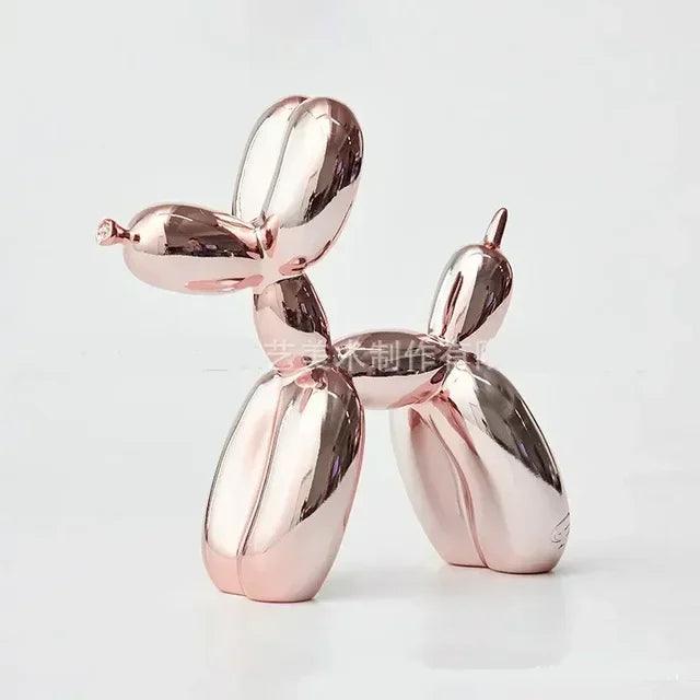 Shiny metallic rose gold balloon dog sculpture with a modern, playful design for home decor against a white background.