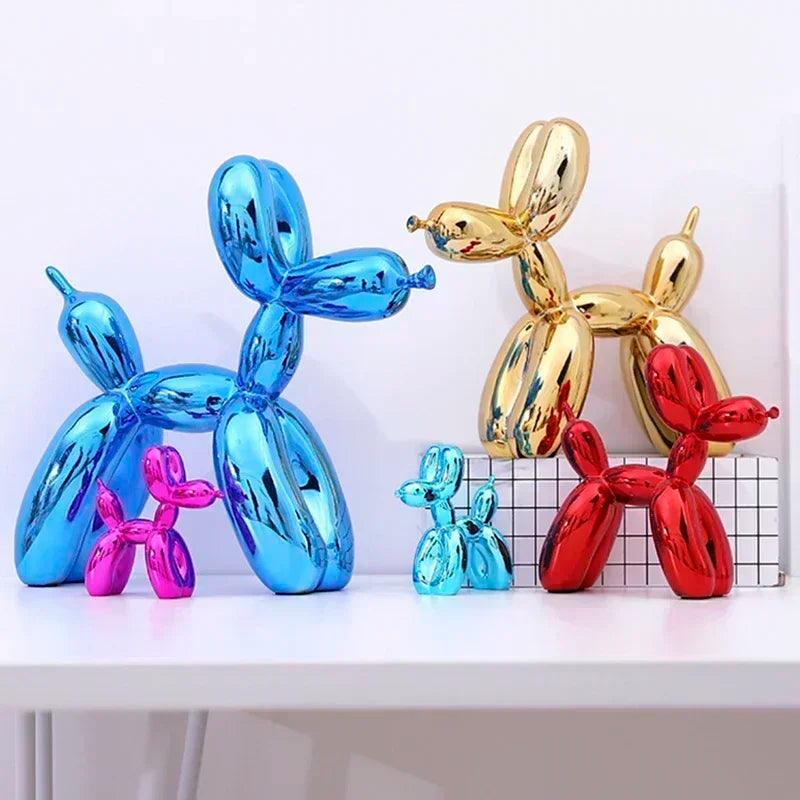 Glossy, metallic balloon dog sculptures in blue, gold, red, and pink, arranged on a white shelf for modern home decor.