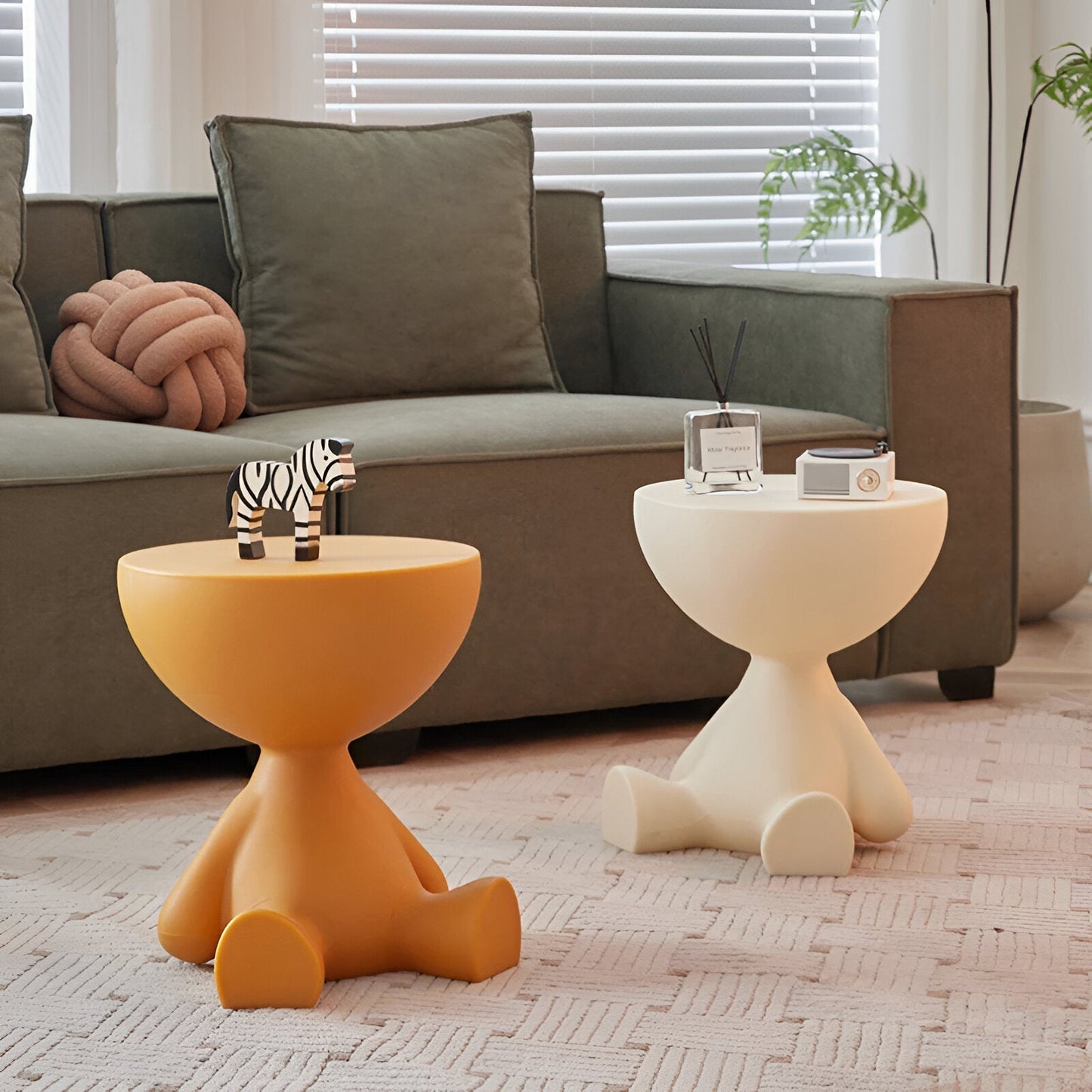Two Fitlybuy Ylix yellow and cream round coffee tables shaped like sitting figures in a modern living room.