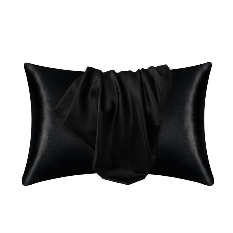 Fitlybuy black satin pillowcase featuring SoftTouch fabric, displayed with elegant folds against a white background.