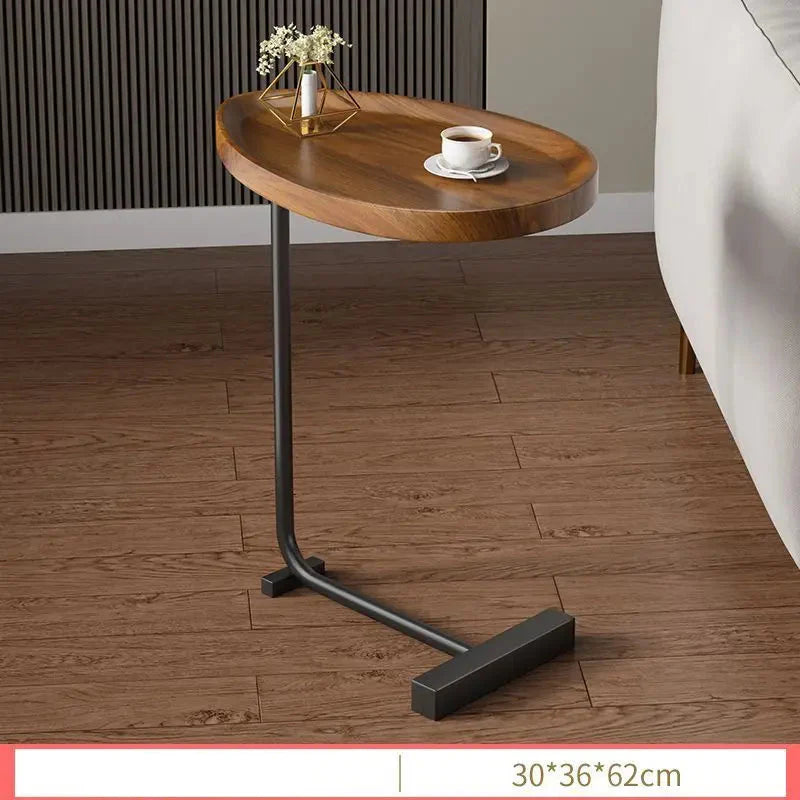 Fitlybuy modern oval wooden C-shaped side table with a black metal base, holding a coffee cup and small vase.
