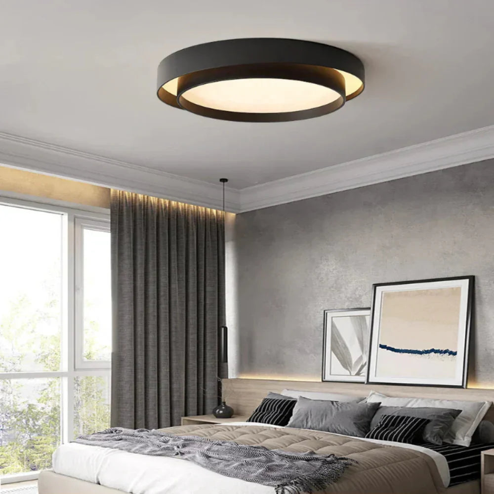 Fitlybuy NordicAura minimalist black LED ceiling light installed in a modern, neutral-toned bedroom.