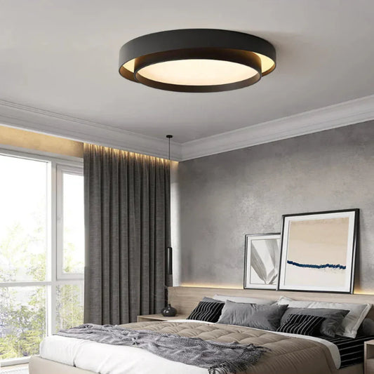 Fitlybuy NordicAura minimalist black LED ceiling light installed in a modern, neutral-toned bedroom.