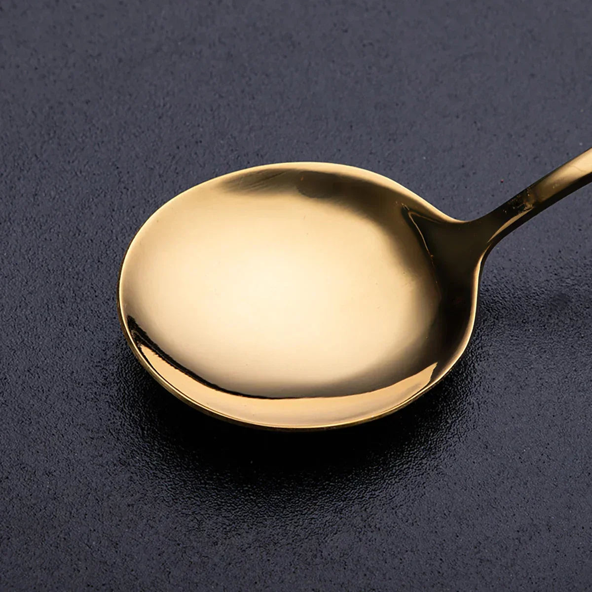 Fitlybuy RoyalMirror luxury gold spoon with a sleek, polished finish, displayed against a dark textured background.