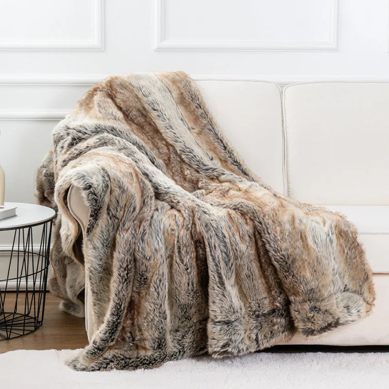 Fitlybuy plush faux fur mink throw blanket with brown, tan, and grey textured pattern draped over a white sofa.