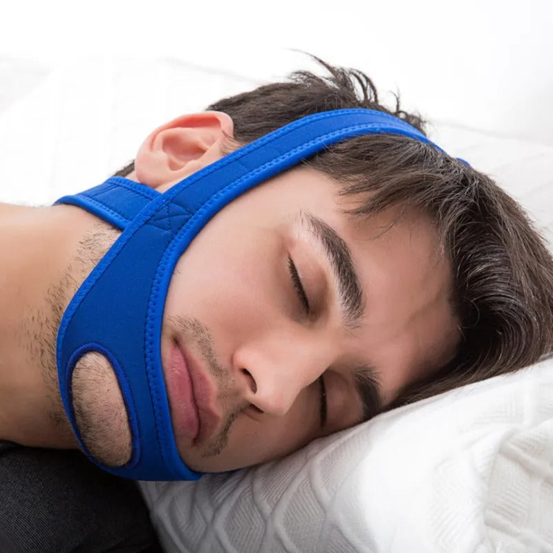Blue Fitlybuy neoprene anti-snore chin strap on a man sleeping in bed with a white pillow for comfort and support.