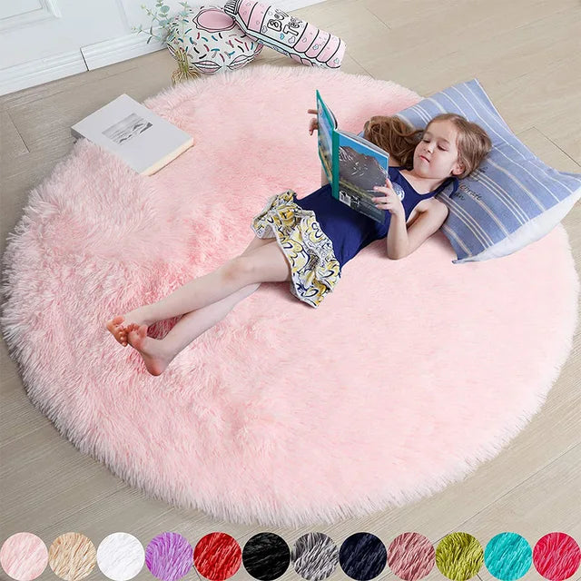 Girl reading on a soft, round, light pink Fitlybuy FluffyMat plush rug featuring CozyCloud comfort technology.