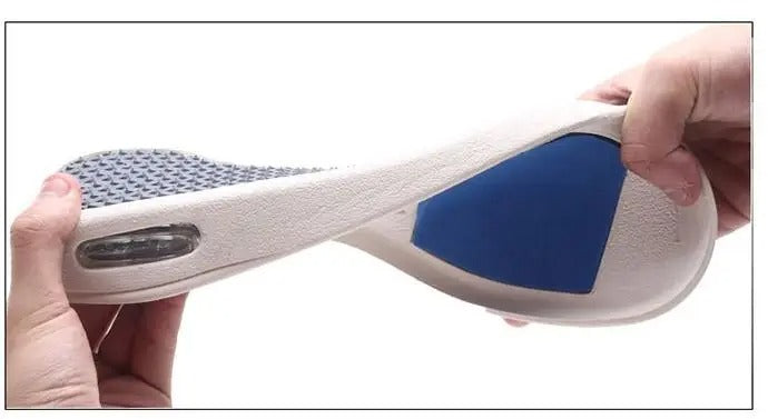 Hands bending a flexible Fitlybuy ComfortStride insole with blue arch support and a shock-absorbing air cushion base.